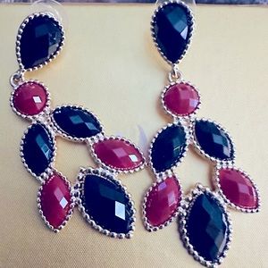 A pair of burgundy and black pierced earrings. Great for any occasion, like new